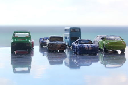 Different miniature colorful (blue, red, green, black, white) cars standing in line showroom car agent sale conceptの写真素材