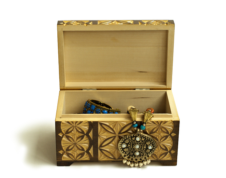 Yellow-brown wooden carved casket with Indian decorations for dancing on a white backgroundの写真素材
