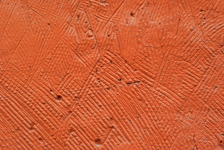 background, texture: orange, deliberately coarse plastered wall of a building close-upの写真素材
