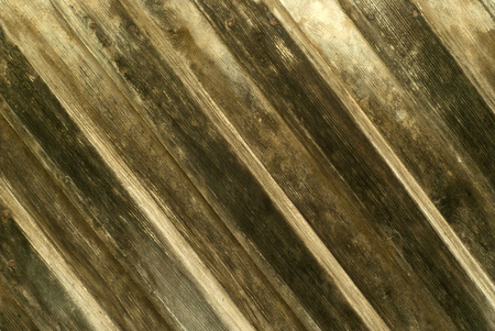background, texture: wall of diagonal overlapping planks darkened from the timeの写真素材