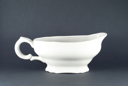 white porcelain sauceboat on a dark backgroundの写真素材