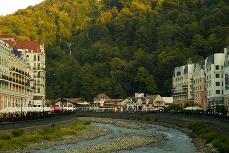 RUSSIA, SOCHY - SEPTEMBER 19, 2017: evening view from the bridge to the embankments along both banks of the Mzymta river in the village of Rosa Khutor in the urban settlement Krasnaya Polyanaのeditorial素材