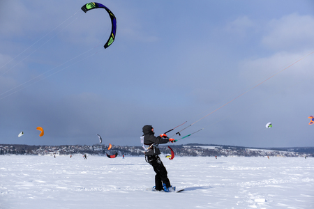 PERM, RUSSIA - MARCH 09, 2018: snowkiters rides on the ice of the Kama Reservoirのeditorial素材