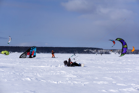 PERM, RUSSIA - MARCH 09, 2018: snow kiters rides on the ice of a frozen riverのeditorial素材