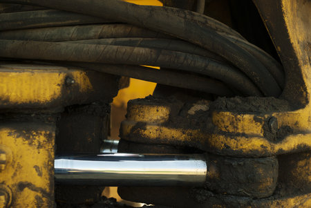 dirty oily fragment of the hydraulic drive of the steering gear of a quarry loader