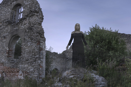 ghost in ruins - a translucent slightly blurred girl in black dress in the dusk amidst a ruined ancient buildingの写真素材