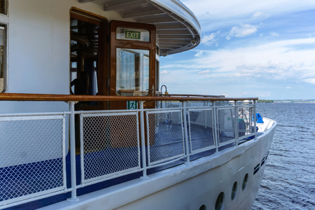 fragment of a river passenger ship ready to sail, with visible inscription the exit at the cabin doorのeditorial素材