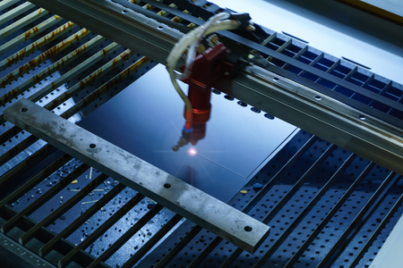 stage of production of printed circuit boards - laser cutting in automatic mode, emitter is blurred in motionの写真素材