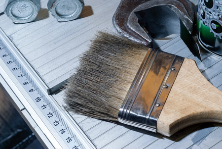 crafting table fragment with tools and brush to remove dust, closeup