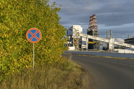 sign "stopping and parking is forbidden" on the background of a road with an industrial landscapeのeditorial素材