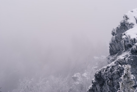 white winter landscape background with snowy natural rock on frame edgeの写真素材