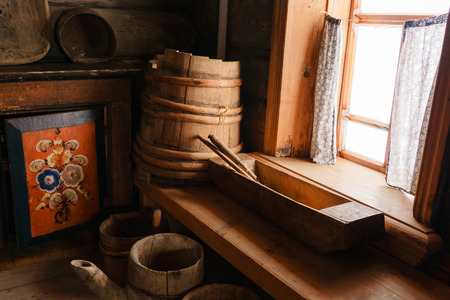 fragment of the interior of an old peasant log cabin - wooden household items and hand painted homemade buffetの写真素材