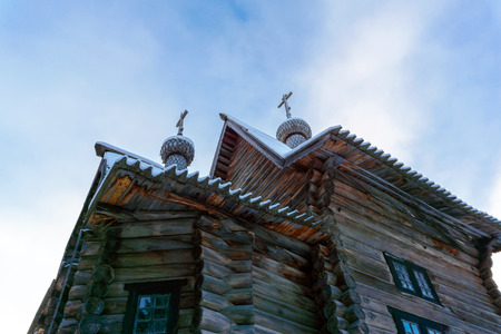 fragment of the facade of old Russian wooden village church against the skyの写真素材