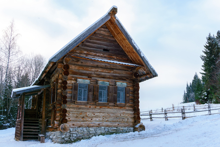 old log Russian peasant hut izba in the winter landscapeの写真素材