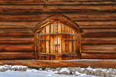 background - closed wooden double gates in the log wallの写真素材