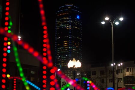 Yekaterinburg, Russia - January 17, 2019: colorful lights - a fragment of New Year's illumination outdoors in the night city and Vysotsky skyscraper on the backgroundのeditorial素材