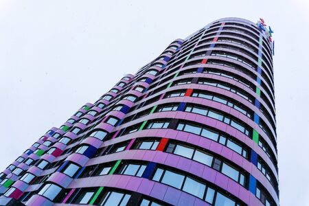 Yekaterinburg, Russia - January 17, 2019: fragment of a multi-colored facade of a modern building during snowfall from the bottom upのeditorial素材
