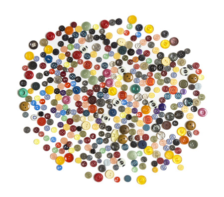 semifinished for background - multicolored plain buttons chaotically arranged on a white surface