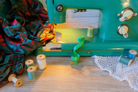 still life with vintage electric sewing machine, cloth and threadの写真素材