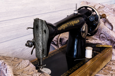 still life with antique sewing machine and fabrics
