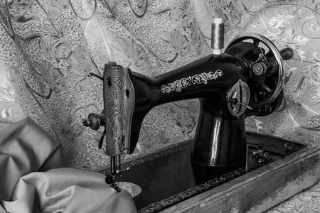 monochrome still life with antique sewing machine and clothの写真素材