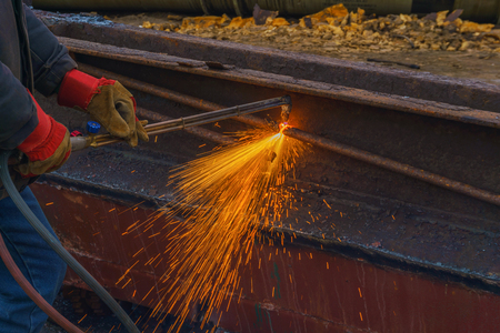 worker cuts scrap metal by thermal lance closeupの写真素材