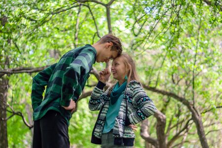 two teenagers communicate and argue outdoor in the parkの写真素材