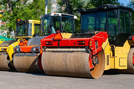 three diesel road rollers rinks standing on the street