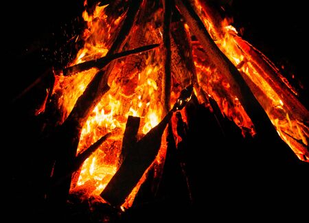 background - flame over burning coals in the darknessの写真素材
