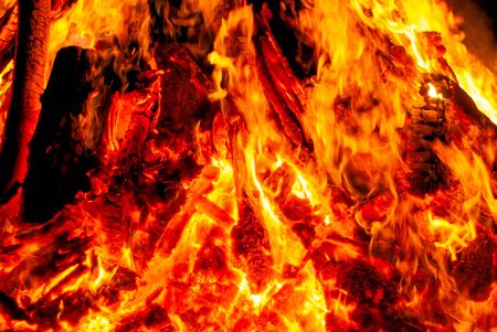 background - flame over burning coals in the darknessの写真素材