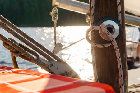 details of rigging sailing boat on blurred shiny water backgroundの写真素材