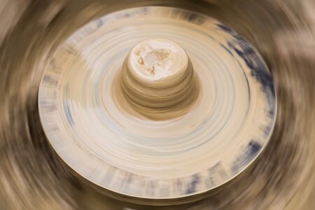 rotating potter's wheel with a lump of clay on itの写真素材