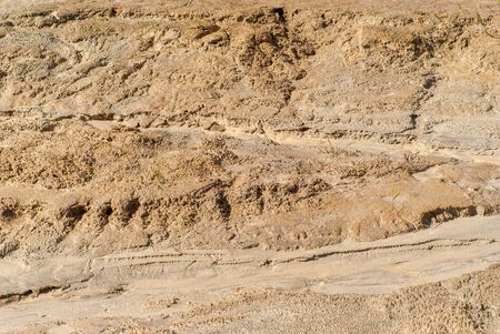 background - a fragment of a dried clay channel of a water stream