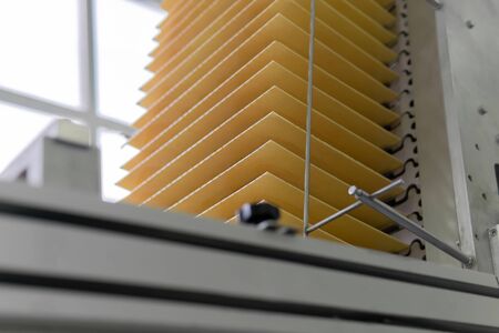 freshly baked wafer sheets rise along the conveyor of a confectionery factory