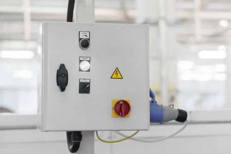 control unit of some production line or machine on a blurred background of the interior of the...
