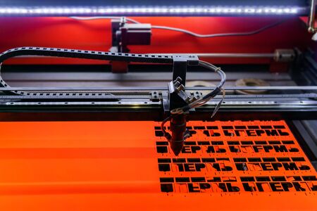 Perm, Russia - November 14, 2019: manufacturing plywood souvenirs on an automatic laser cutting...