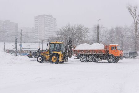 Perm, Russia - December 24, 2019: snow removal works by road equipment during extreme snowfallのeditorial素材