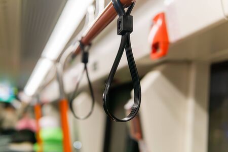 interior elements of public transport - handrail for standing passengers - on a blurred backgroundの写真素材
