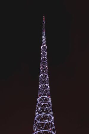 Perm, Russia - January 12, 2020: purple night illumination of the television tower against the dark...