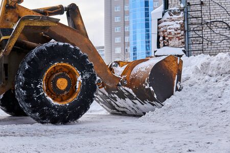 close-up - loader bucket removing  snowdrift