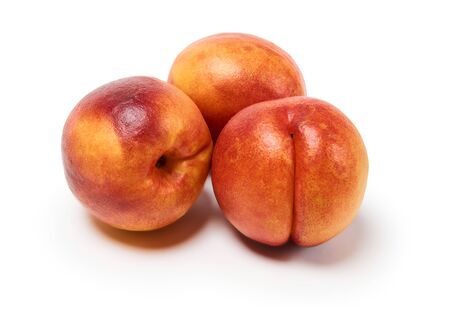 three ripe nectarines on a white background, isolated with a shadowの写真素材