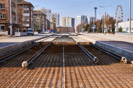 Perm, Russia - April 15, 2020: construction of the tram network was suspended due to quarantine during the COVID-19 pandemic; unfinished rails on a background of a deserted city streetのeditorial素材
