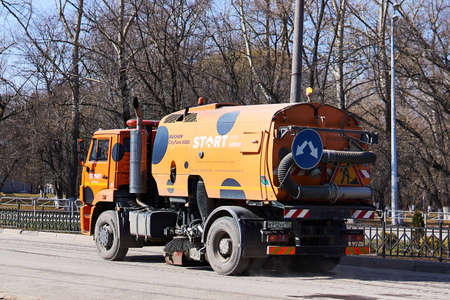 Perm, Russia - April 15, 2020: large orange street sweeper machine based on KamAZ in spring streetのeditorial素材