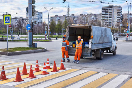 Perm, Russia - May 01, 2020: workers are waiting for the pedestrian crossing marking paint to dryのeditorial素材