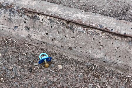 lost baby pacifier lies on the side of the roadの写真素材