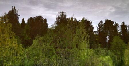 blurred abstract natural background - evening spring forest reflected in river waterの写真素材