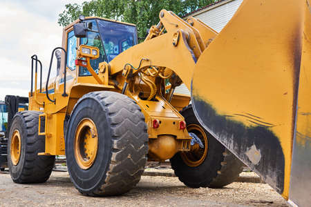 large industrial wheel bucket loader close-up outdoors