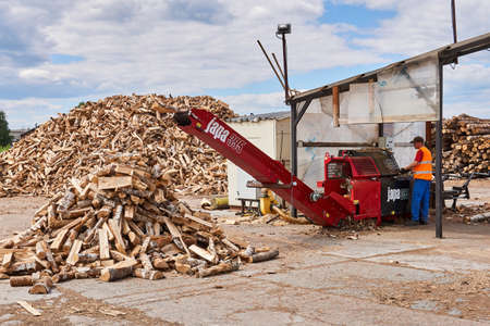 Perm, Russia - May 29, 2020: modern firewood processor in operationのeditorial素材