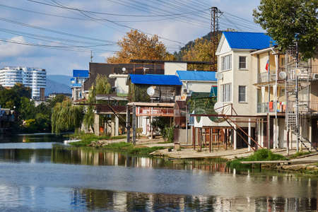 Sochy, Russia - September 14, 2020: the bank of the Dagomys River is entirely built up with small cottages with garages for boatsの写真素材
