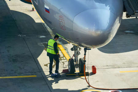 Moscow, Russia - September 16, 2020: airport services check the aircraft systems in the parking lot...